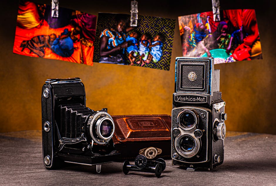 Vintage cameras displayed with vibrant photos hanging above. Classic and artistic feel.